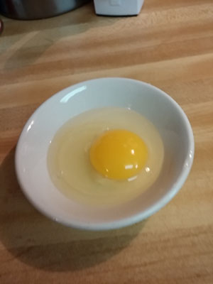 Crack open egg into small dish